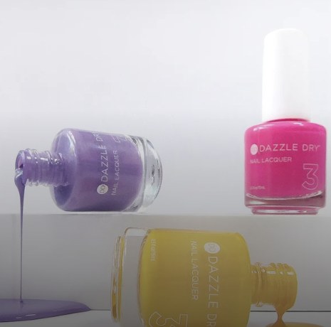Dazzle Dry nail lacquer bottles in purple, pink and yellow