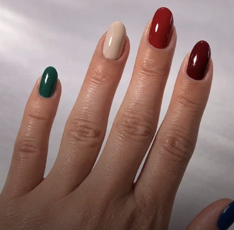 A hand with nails painted in Dazzle Dry colours