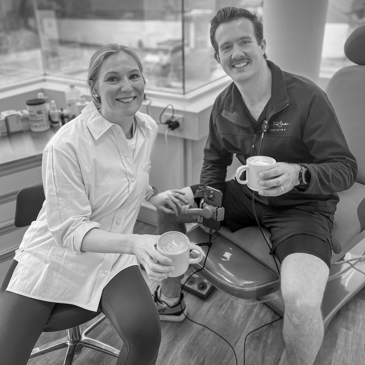 Two of our podiatry team sharing a coffee in a consult room at The Foot Studio